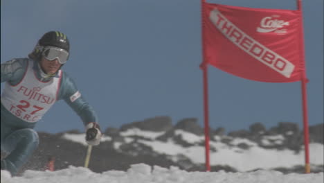 a skier skis around a sign and continues downhill