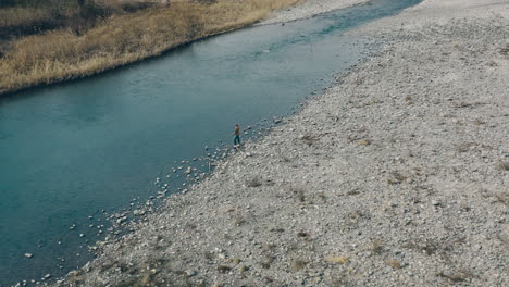 Man-Is-Fishing-On-Calm-Tamagawa-River-Near-Haijima-Bridge-In-Tokyo,-Japan