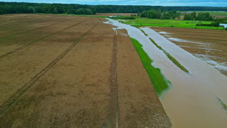 overflown ditch flooded fields in latvia, aerial view
