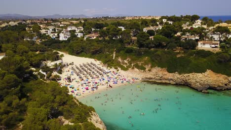panning from the left to the right side of the frame in front of the secluded beach of cala anguila, a beautiful resort in the island of mallorca in spain