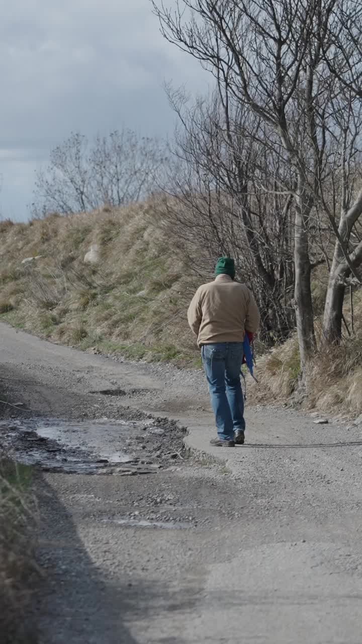 A person walking down a dirt road