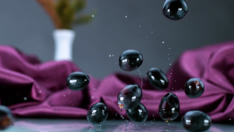 black grapes gracefully cascade onto a flat surface, delicately rebounding in slow motion, embodying elegance and the concept of natural abundance