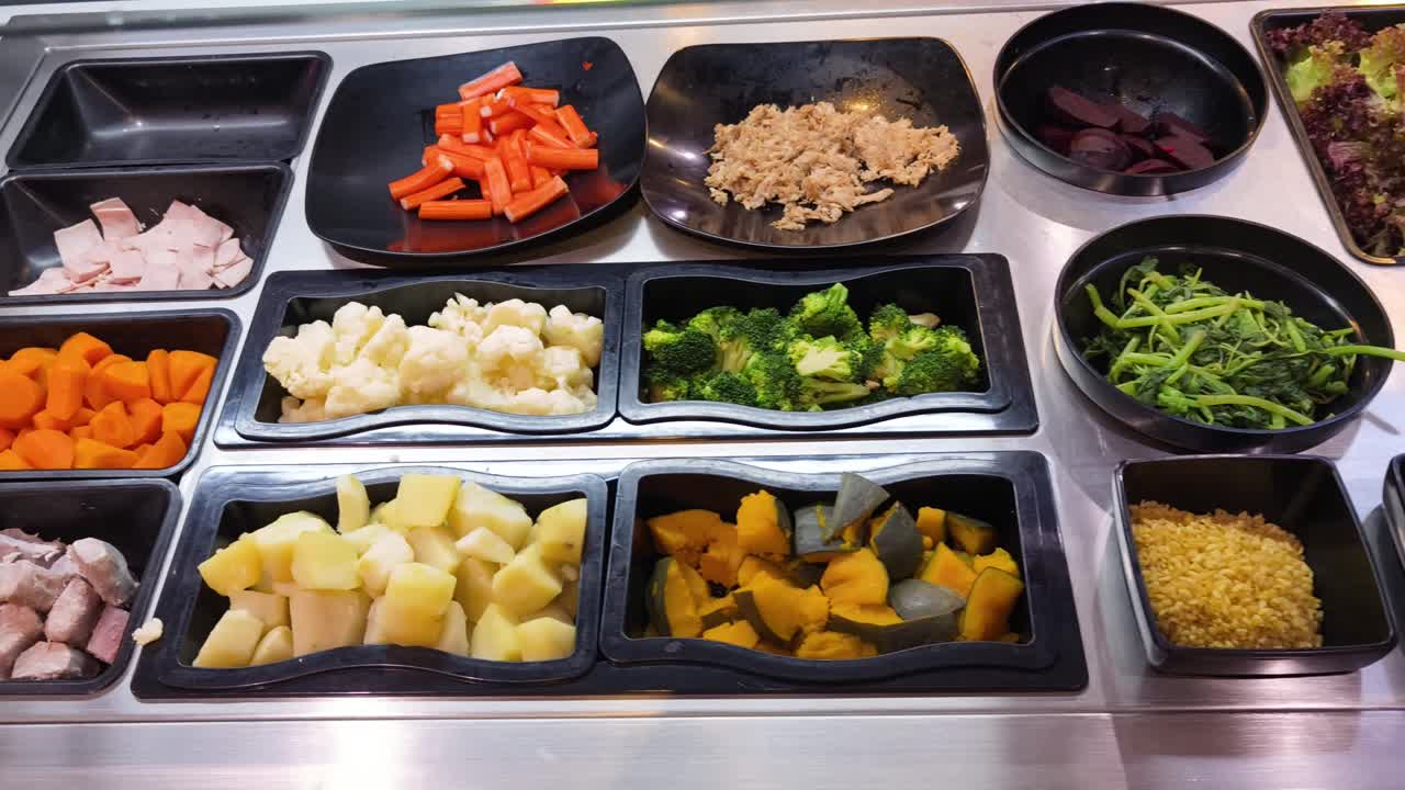 Self-service salad bar with various ingredients