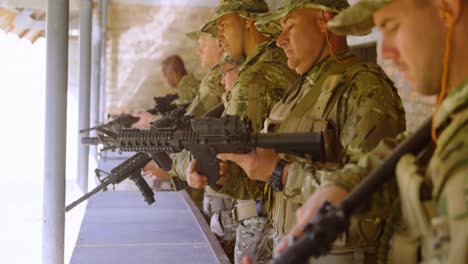 Side-view-of-mixed-race-military-soldiers-loading-weapon-during-military-training-4k