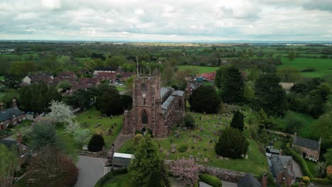 St-Boniface,-Bunbury,-Cheshire---a-quintessential-English-village-Church---Aerial-drone-clockwise-fast-pan,-May-23