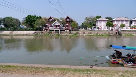 a long boat travels along a river