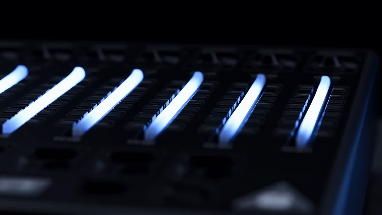 Blue Glowing Faders Moving on a Sound Mixer Control Panel