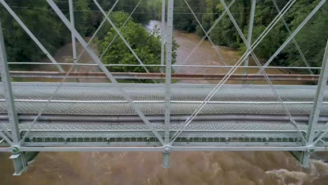 drone side shot of an old metal bridge