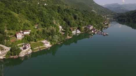 aerial view of the settlements on the shores of lake jablanica in bosnia, drone shot of the bridge built over the river