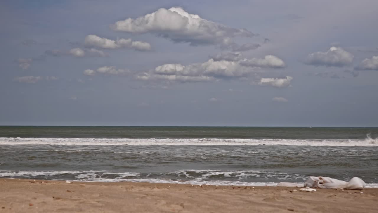 gandhi beach with clouds and sand at marina beach, triplicane, chennai, tamil nadu, india. day time, stable shot, 4k.