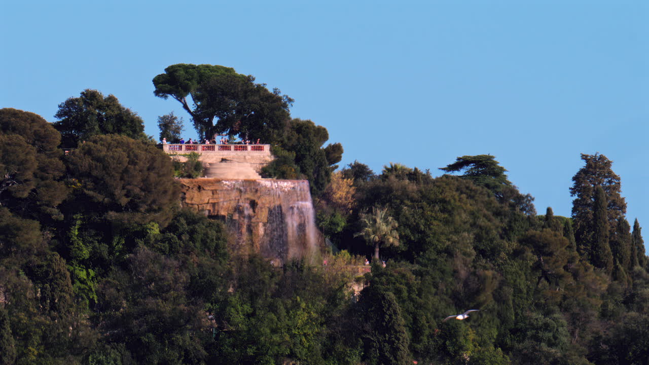 Nice, France - March 17, 2025: Distant view of the Cascade du Chateau on the Chateau hill in daylight