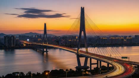 a stunning transformation: the spectacular journey of a modern bridge at sunset into the quiet serenity of night's embrace with reflected city lights