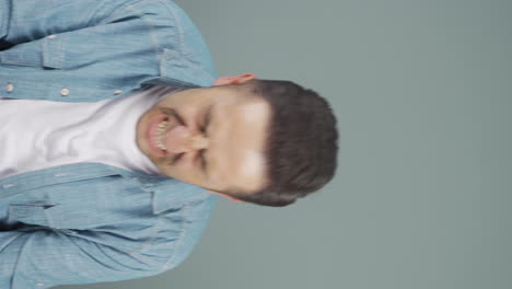 Vertical-video-of-Man-having-a-nervous-breakdown-in-front-of-the-camera.