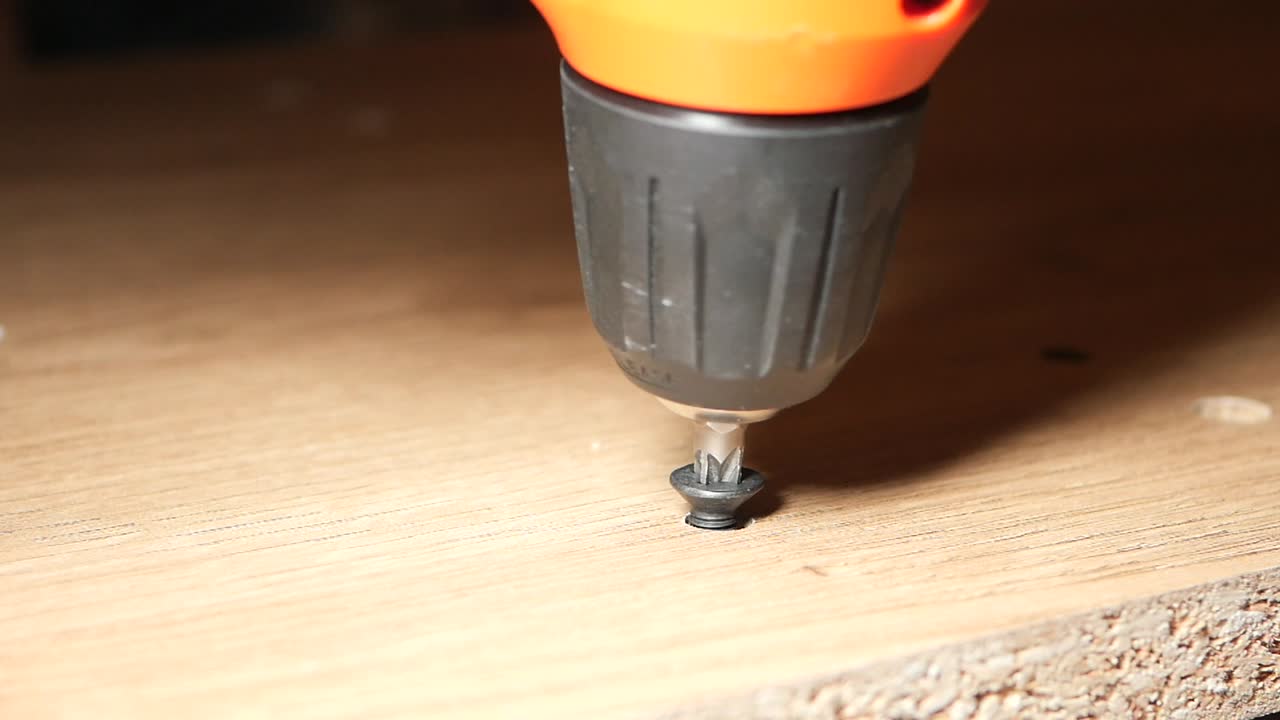 Using a drill to assemble wooden furniture