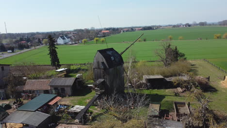 old wooden windmill in a rural landscape