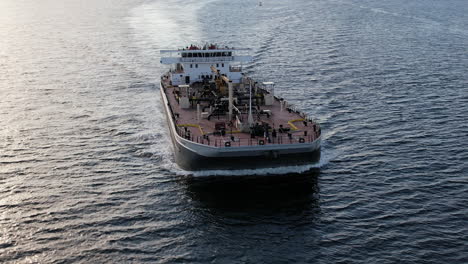 aerial around forward bow of tanker ship sailing through open sea