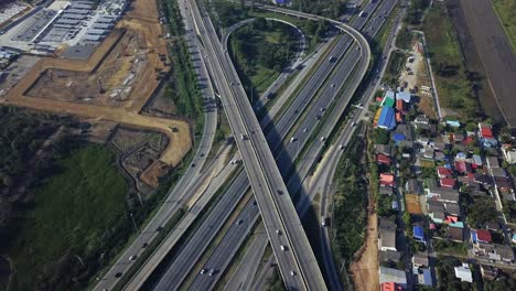 scenic aerial view above busy highway intersection ramp with traffic in industrial area