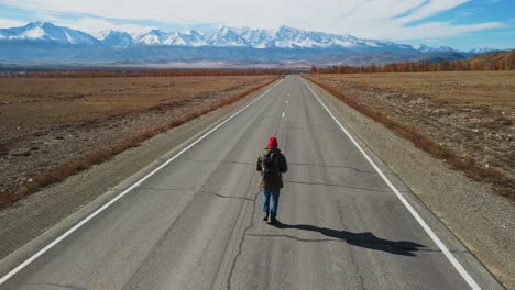 a traveler on a mountain road