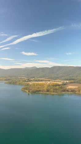 aerial view of a serene lake surrounded by mountains
