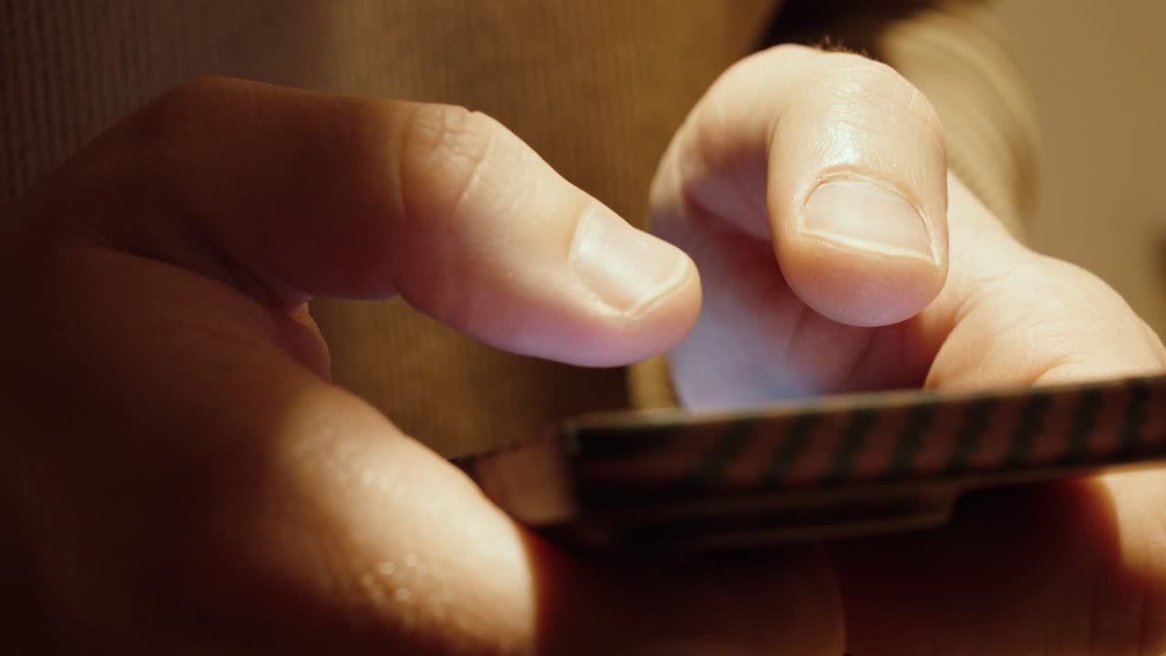 Extreme close-up of a thumb typing on a smartphone screen. Concept of mobile communication, texting, digital interaction, and modern technology use