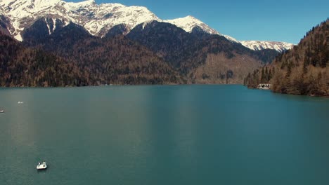 drone is lowering and landing showing beautiful mountains and pond landscape