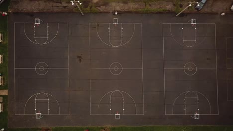 Aerial-View-of-three-outdoor-basketball-courts-found-at-a-local-park