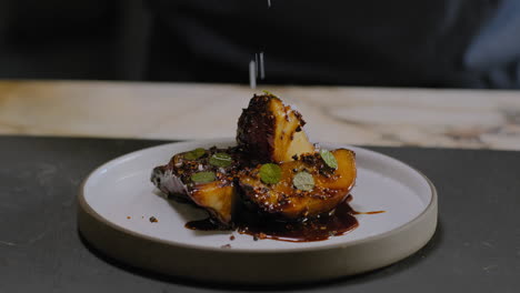 slow motion shot of a chef plating a gourmet sweet potato dish in a restaurant