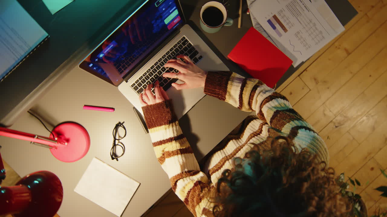Woman Analyzing Stock Market Data on Laptop during Night