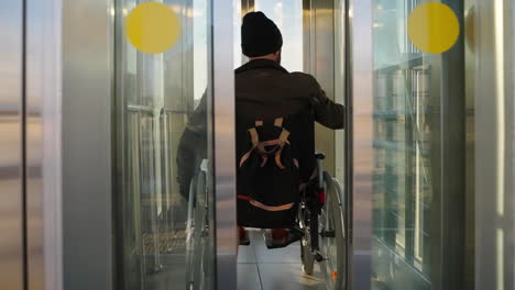 person in wheelchair entering an elevator