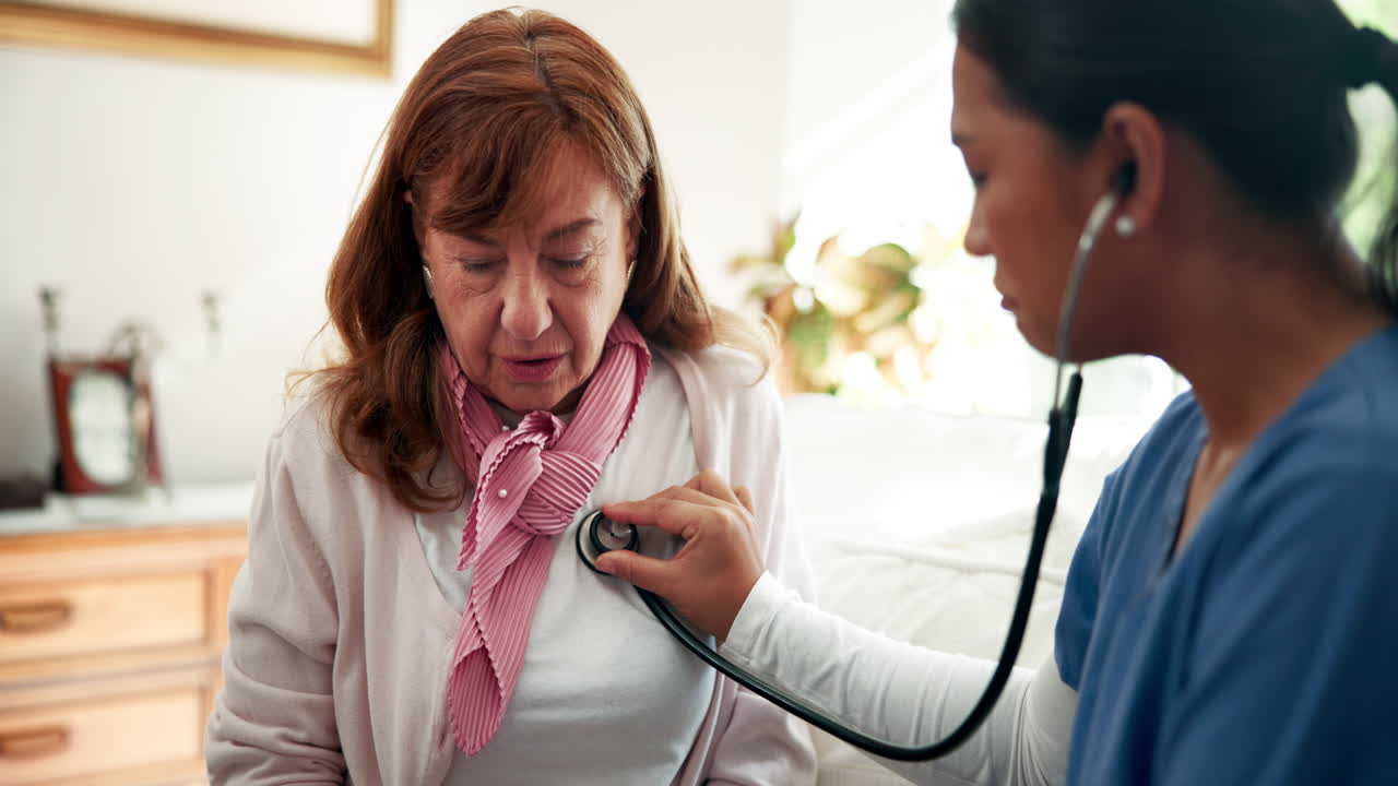 Medico che visita un'anziana con lo stetoscopio
