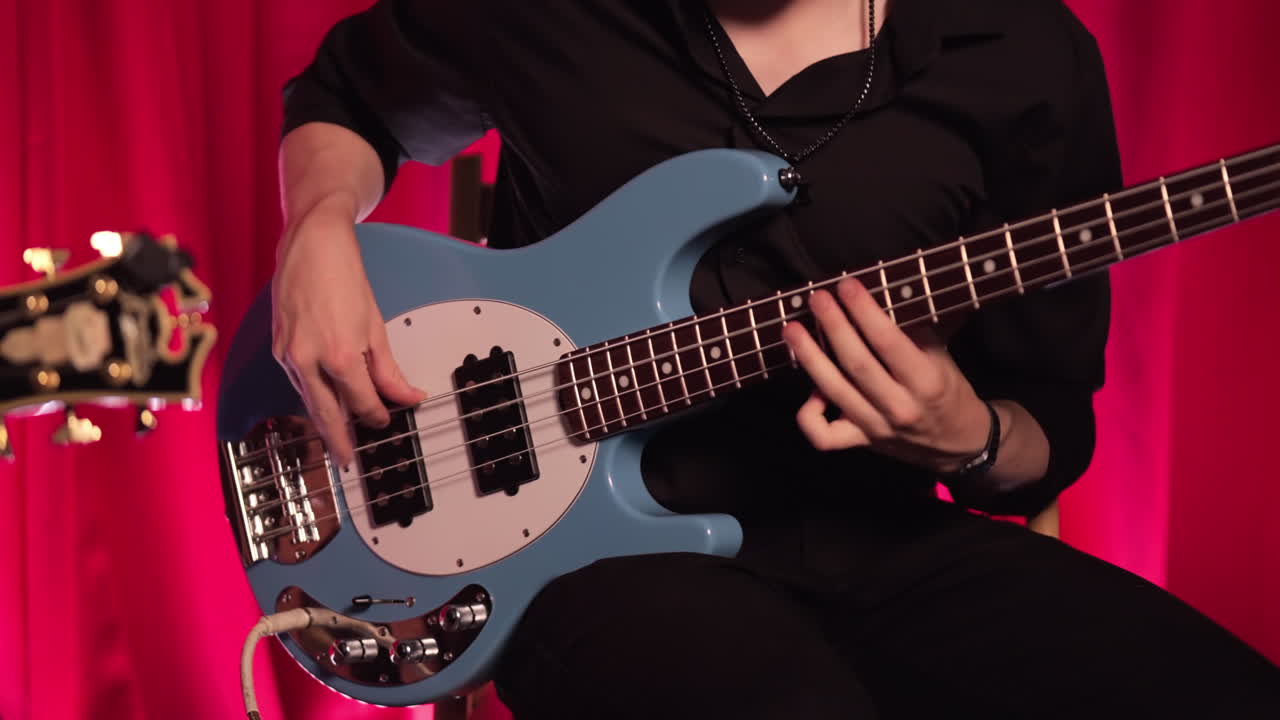 A Passionate Musician Using A Bass Guitar On Stage. Reveal Shot