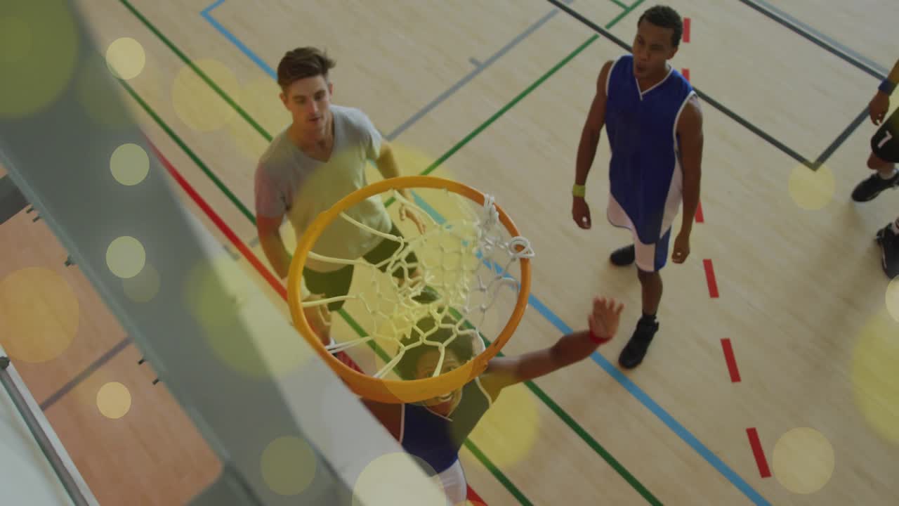 Sports blue player sprinting toward hoop after ball entry and completing dunk over guards to score