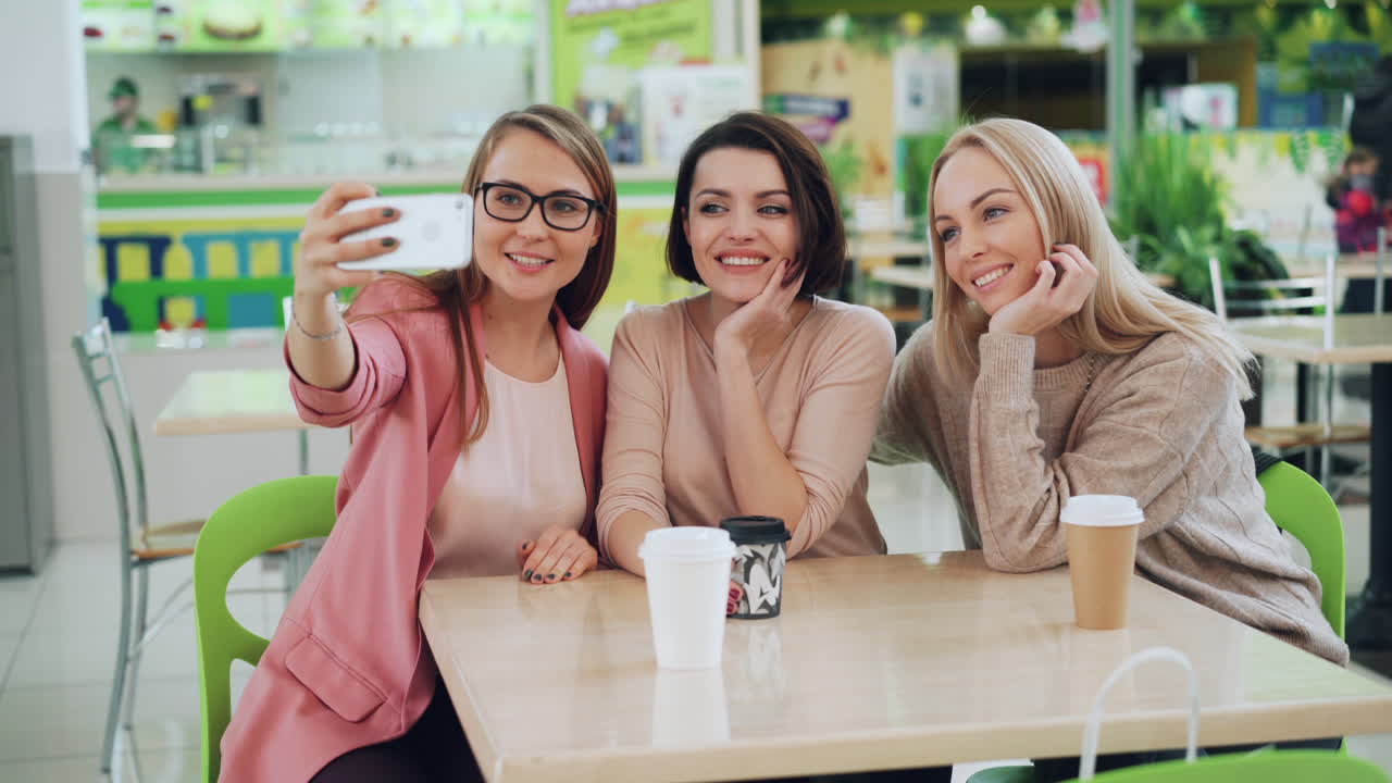 Friends taking a Selfie in a Food Court