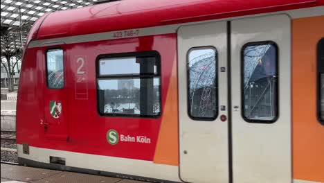 s bahn passes close to the camera from a train station in germany