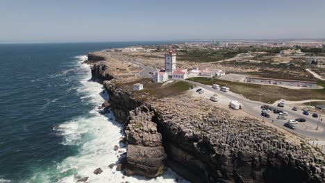 aerial orbiting view coastal lighthouse of cabo carvoeiro, peniche - portugal