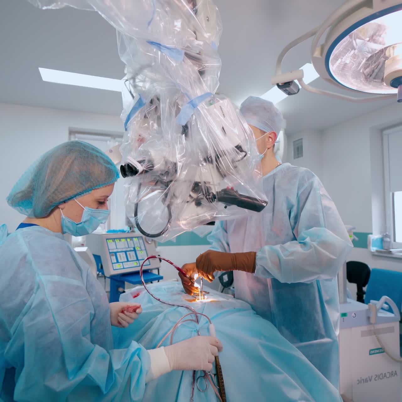 Medical team in the neurosurgical department. Specialists in medical uniform performing a neurosurgery. Modern medical equipment in the operating theater.