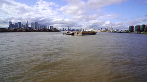 tilting view revealing east london with docklands and canary wharf on one side and greenwich and the millennium dome on the other