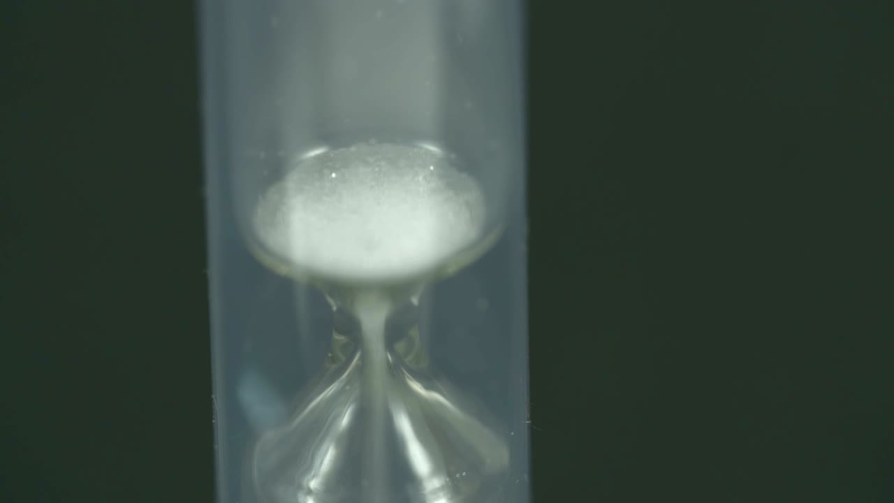 The last drops of sand are dropping in the hourglass