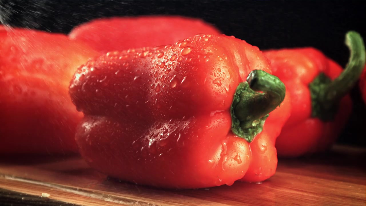 Peperone rosso vivace coperto di goccioline d'acqua fresca.