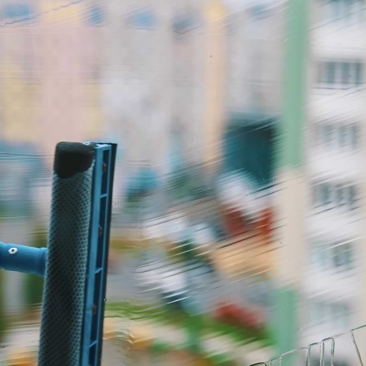 Close up view of cleaning wet window. Water cleaner with wet glass