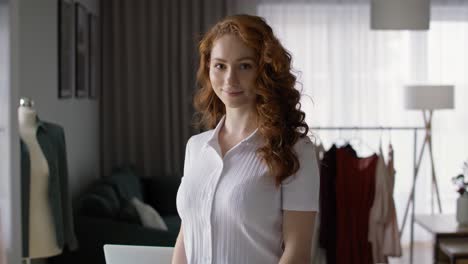 portrait of caucasian ginger woman in workshop.