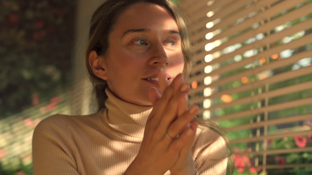 Brunette woman talking near a window in a restaurant