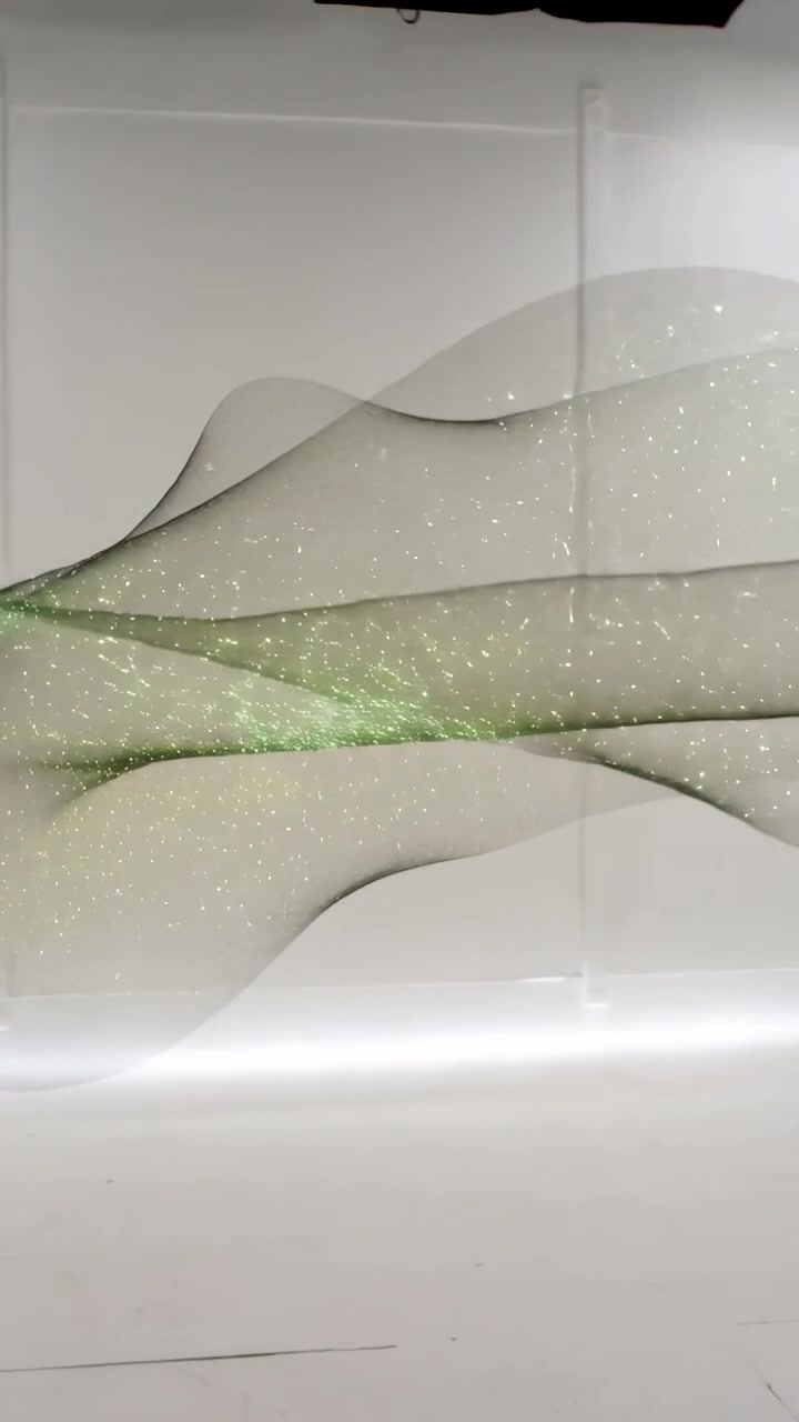 Vertical video: Drifting ribbon mesh shifting in white studio from softbox pulse, showing lime dots