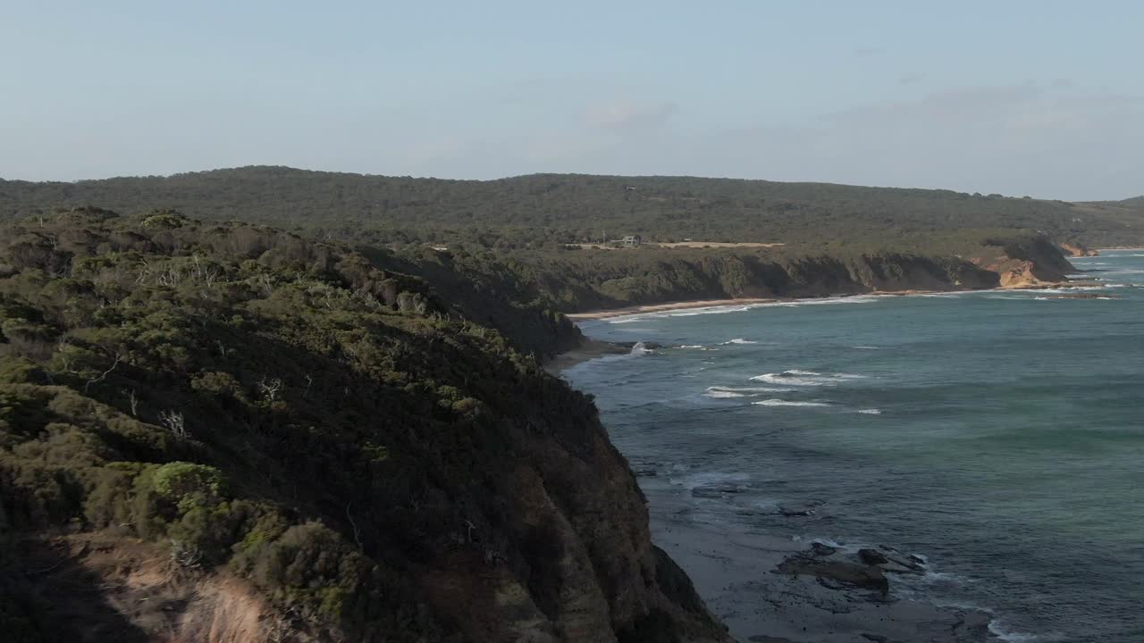 4K aerial fly-by high cliff on ocean