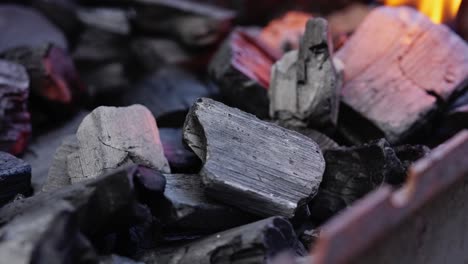 charcoal ignites with sparks flying as flames build for outdoor cooking or grilling