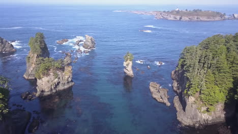 Aerial:-Rainforest-islands-and-sea-stacks-in-blue-north-west-Pacific