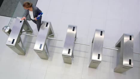 Businesswomen-scanning-their-cards-at-turnstile-gate