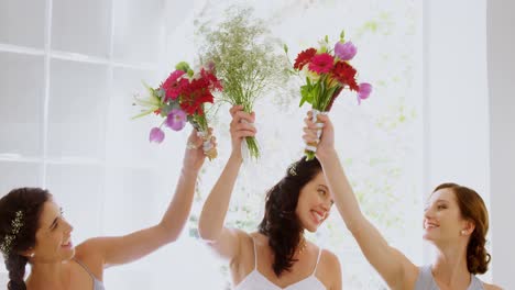 bridesmaids and bride having fun holding flowers in the air 4k 4k