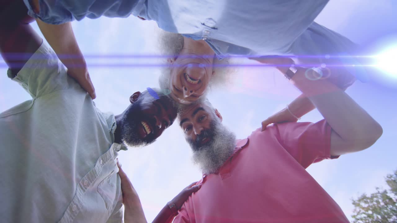 Three adults huddling over camera, man pointing, cheering for ads under lens flare and blue cap
