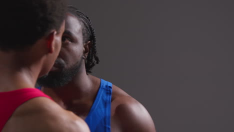 Close-Up-Of-Male-Boxer-And-Opponent-Standing-Face-To-Face-Before-Boxing-Match-Staring-At-Each-Other-8